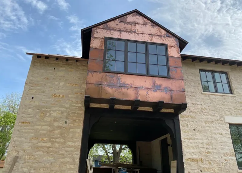 Copper metal panel facade on a stone building for Skylight Installation in Madisonville
